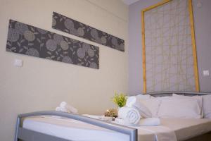 Postel nebo postele na pokoji v ubytování Kasimidis Apartments