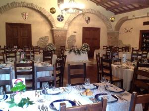 a dining room with tables and chairs in a building at Hotel Residence La Fortezza in San Lucido