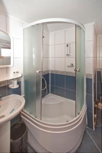 a bathroom with a shower and a sink at Casa Tudor in Sinaia