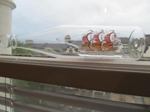 a glass case with shoes in it on a window at The Beatnik, Victorian townhouse apartment with parking in Plymouth