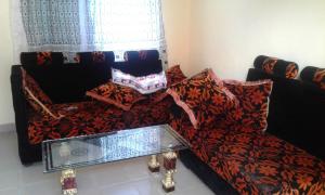 a living room with a couch and a chair at JJ & JE Family House in Dar es Salaam