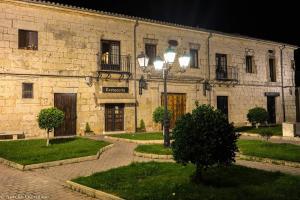 a building with a street light in front of it at HOSTAL Villa de Brulles in Villadiego