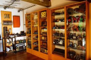 a large wooden cabinet filled with lots of items at HOSTAL Villa de Brulles in Villadiego