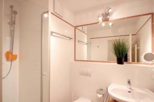 a bathroom with a shower and a sink and a mirror at Villa Laetitia - by Rujana in Binz +177 photos