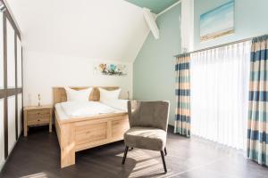 1 dormitorio con 1 cama y 1 silla en Hotel Werner en Mornshausen