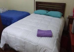 A bed or beds in a room at Hospedaje Familiar