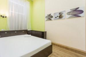 a small room with a bed and a window at Aparton Engelsa 28 in Minsk