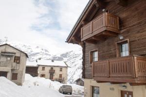 a wooden house with a balcony on the side of it at Chalet Li Baita Genny in Livigno