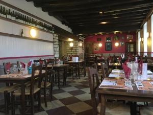 a dining room with wooden tables and chairs at Hotel du Rempart in Sancerre