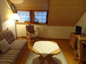 a living room with a couch and a table at WASSERSTELZ Historisches Genusshotel & Restaurant am Rhein in Hohentengen