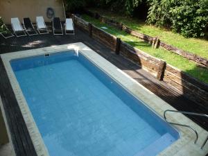 a swimming pool in a yard with chairs at Rincón Del Golf in Pinamar