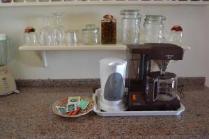 a coffee maker sitting on a counter next to a basket at Casal São João Cottages 106 in Fajã da Ovelha