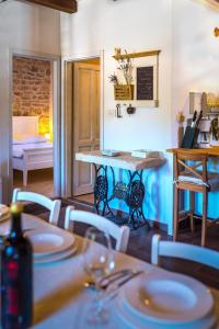 a dining room with a table and chairs and a kitchen at Rural house Mudrinic "Ivini dvori" in Bogatić