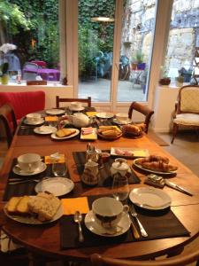 a wooden table with food on top of it at Les Chambres d'Art in Bordeaux