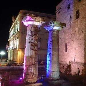 dos columnas delante de un edificio por la noche en B&B Il Tulipano en Taranto
