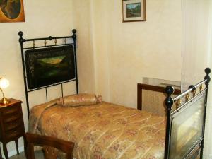 a bedroom with a bed and a tv on the wall at I 13 Cavalieri Guest House in Barletta