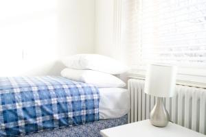 a bedroom with a bed and a table with a lamp at Access Little Venice in London +4 photos