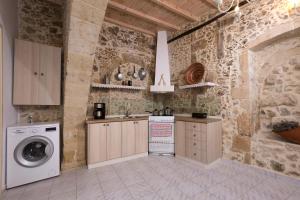 a kitchen with a sink and a washing machine at Trigono Kaliviani, 4BDR - 3BR - 8 people in Kissamos