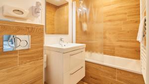 a bathroom with a white sink and a shower at Logis Hôtel La Chaize in Noirmoutier-en-l'lle