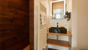 a bathroom with a sink and a mirror at Logis Hôtel La Chaize in Noirmoutier-en-l'lle
