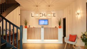 a lobby with a counter and a chair at Logis Hôtel La Chaize in Noirmoutier-en-l'lle