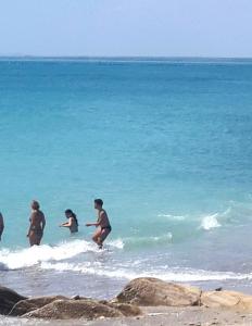 a group of people playing in the water at the beach at Akrotiriya Sea View in Nesebar