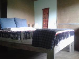 a bed with a blanket on it in a room at apto con vista al mar in La Paloma