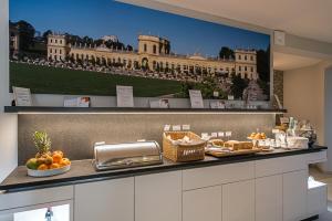 a kitchen with a picture of a building on the wall at BioHotel Kassel Wilhelmshöher Tor in Kassel