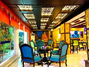 a restaurant with chairs and a table in a room at Petra Sella Hotel in Wadi Musa