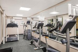 a gym with treadmills and elliptical machines at Howard Johnson by Wyndham Middletown Newport Area in Middletown