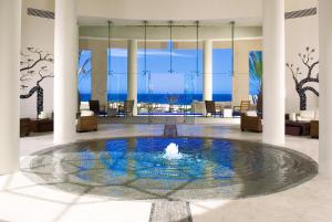 a lobby with a fountain in the middle of a room at Pueblo Bonito Pacifica Golf & Spa Resort - All Inclusive - Adults Only in Cabo San Lucas