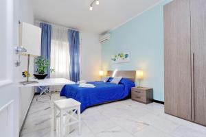 a bedroom with a blue bed and a desk at I Pini di Roma - Rooms & Suites in Rome