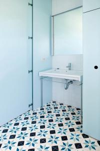 La salle de bains est pourvue d'un lavabo et de carrelage noir et blanc. dans l'établissement Hotel-Bodega Finca de Los Arandinos, à Entrena