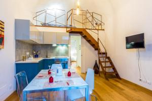 a kitchen with a blue table and a spiral staircase at Garibaldi 13 in Turin +12 photos