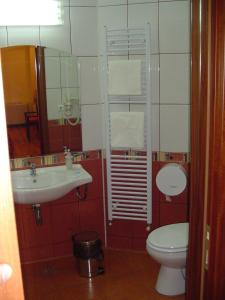 a bathroom with a toilet and a sink at Hotel Europa in Ploieşti +32 photos