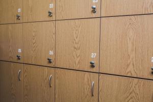 a row of wooden cabinets with numbers on them at Hostel Bed&Bread in Dnipro