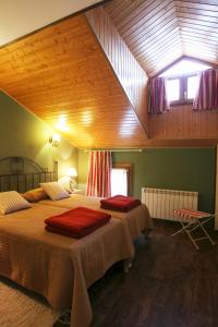 a bedroom with two beds with red blankets on them at Apartamentos la Demanda in Ezcaray