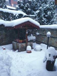 einen schneebedeckten Hof mit einem Pavillon in der Unterkunft Hotel Bilyana in Lovech