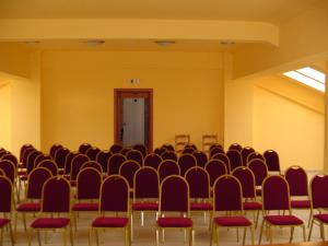 an empty room with chairs and a door at Hotel Europa in Ploieşti