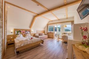 a bedroom with a bed and a living room at Molaris Lodge in Mühlbach