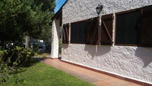 un edificio blanco con ventanas y una lámpara. en Jacarandá, en La Paloma