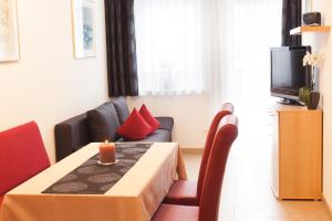 a small living room with a table and a couch at Apart Alpenblick in Pfunds