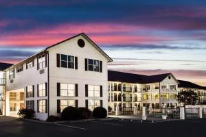 a building in a parking lot in front of a building at Super 8 by Wyndham Sevierville Riverside in Sevierville
