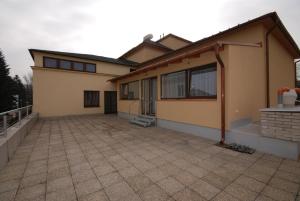 a house with a large patio in front of it at Penzion Růže in Humpolec