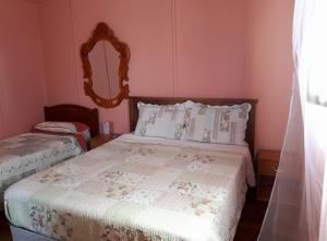 a bedroom with a bed with a mirror on the wall at Hospederia Taltal in Taltal