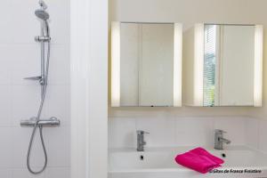 a bathroom with a sink and a shower with a pink towel at La maison du port in Plougasnou +15 photos