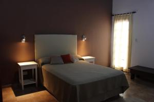 En eller flere senge i et værelse på Villa Leandro