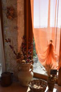 a window with two vases on a table next to a window at B&B Le Terrazze in Perugia