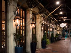 a hallway of a building with potted plants and lights at The Old No. 77 Hotel & Chandlery in New Orleans