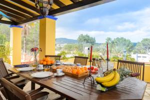 a wooden table with fruits and vegetables on a balcony at Villa Can Palazon in Ibiza Town